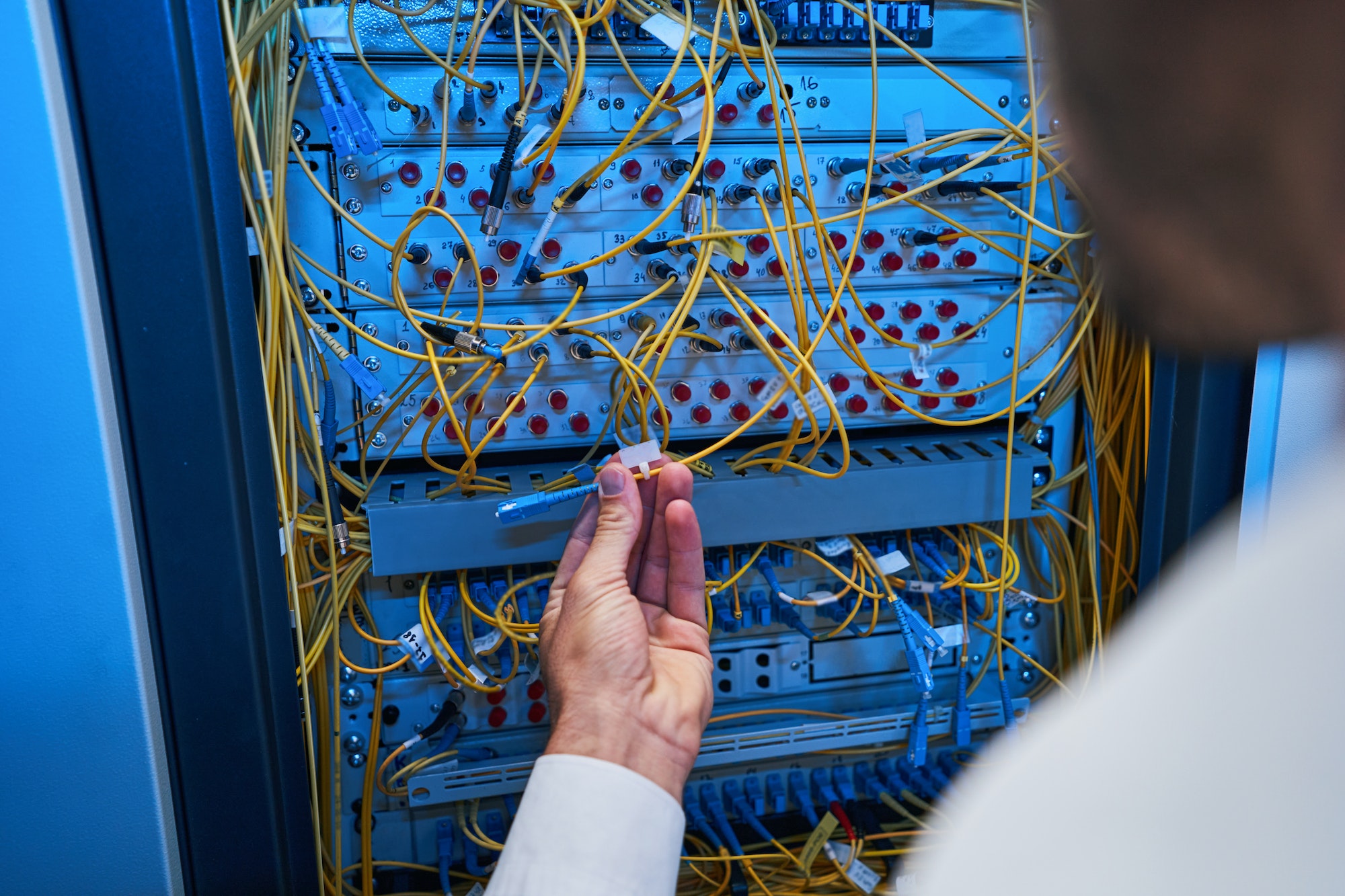 Fiber-optic cable in hand of server administrator